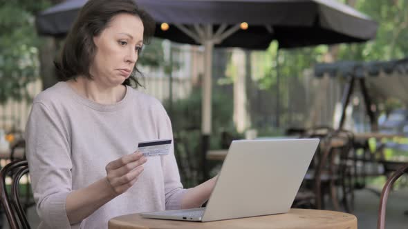 Online Shopping Failure for Old Woman Sitting Outdoor