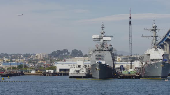 Navy ships anchored near a bridge