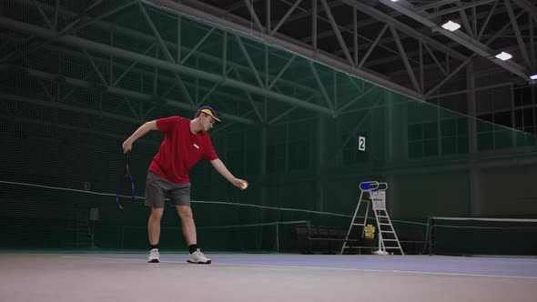 Serve of Professional Tennis Player on Indoor Tennis Court Training and Practicing Strikes By