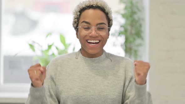 Portrait of Excited African Woman Celebrating Success