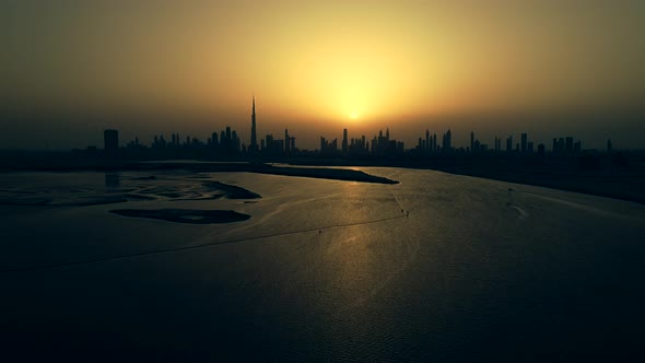 Grading aerial view of Dubai skyscrapers at sunset, UAE.