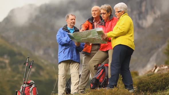 Four Senior Hikers Looking at Map Close