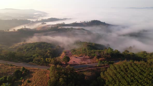 4K Aerial view from drone over mountains fog. Golden scenery at sunrise, Nan, Thailand