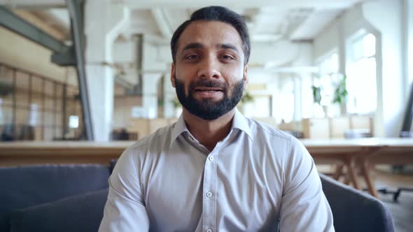 Happy Indian Business Man Talking to Webcam Having Virtual Meeting in Office