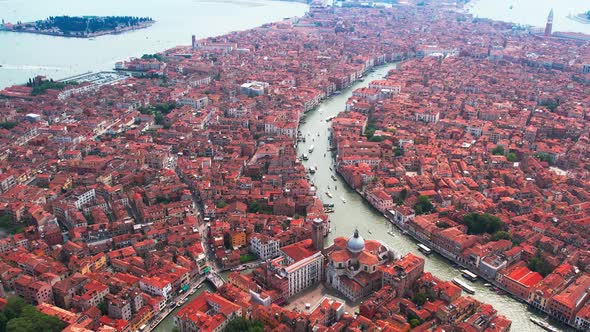 Aerial View Over Orange Rooftop Buildings In Venice. Dolly Back And Pan