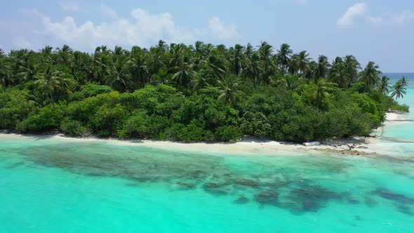 Luxury fly over island view of a white sand paradise beach and aqua blue ocean background in colourf