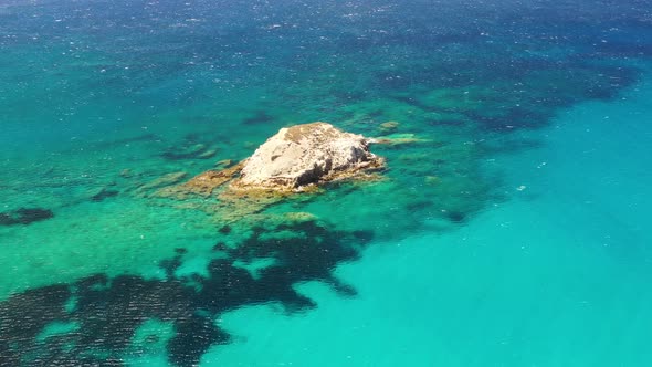 Aerial seascape at the day time. Bay and rocks. Blue water background in the summer.