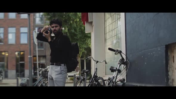 Man taking pictures of a car