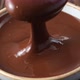 melted chocolate pouring into bowl from spoon, slow motion  - VideoHive Item for Sale