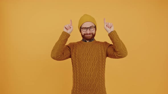 Young Cheerful Man Pointing Up Medium Shot Studio Shot Orange Background