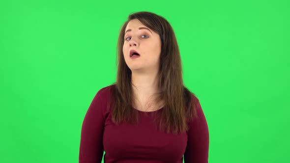 Portrait of Funny Girl Is Smiling Broadly and Winking. Green Screen