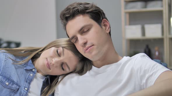 Sleeping Tried Young Couple on Couch