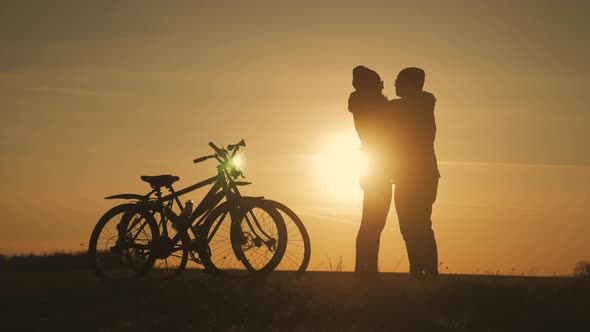 Couple Silhouettes of Cyclists on a Sunset Time