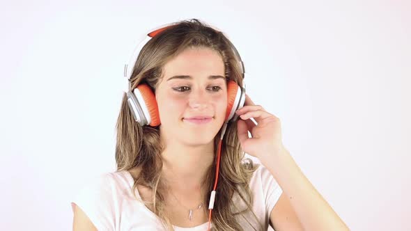 Smiling Young Woman Listening Music with Headphones