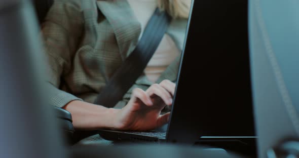 Unrecognisable Business Woman Working on Laptop While Sitting on Back Seat of Car