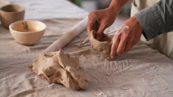 Woman potter sculpting of clay