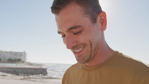 Young man on a beach smiling