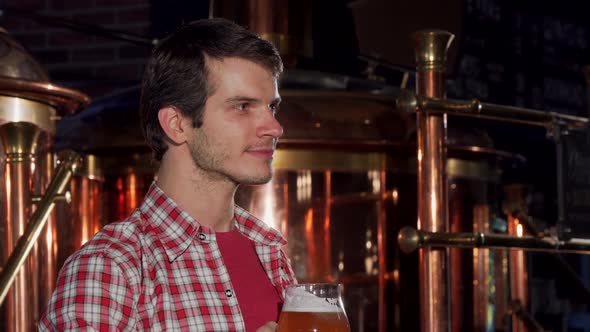 Professional Male Brewer Drinking Craft Beer at His Own Brewery