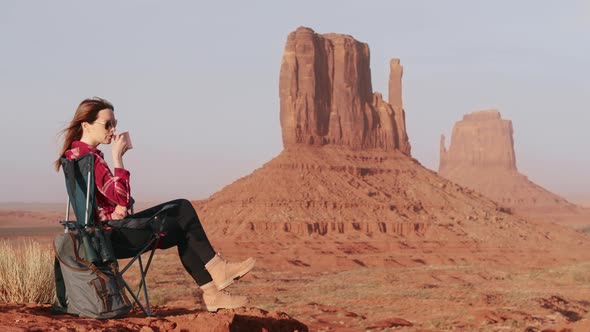 Explorer Woman on Adventure Traveller Drinking Tea with Cinematic Background