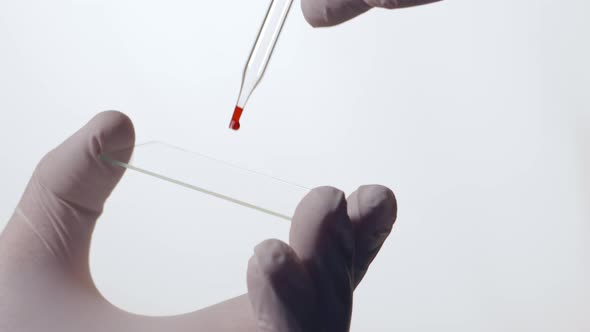 Dropping a Blood Sample Onto a Microscope Glass