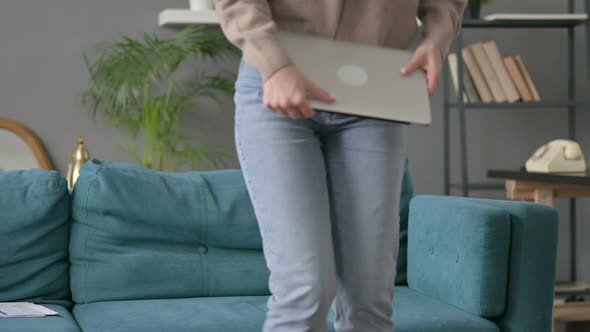 Woman Siting on Sofa Opening Laptop