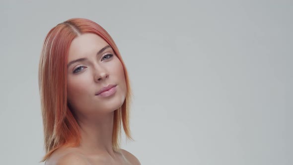 Studio portrait of young, beautiful and natural redhead woman. Beauty concept.