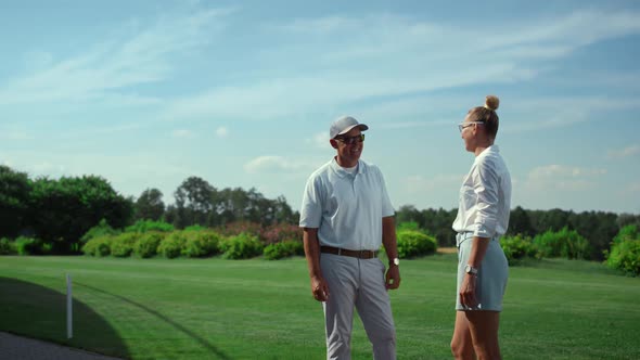 Two Golfers Talking Sport on Course Field