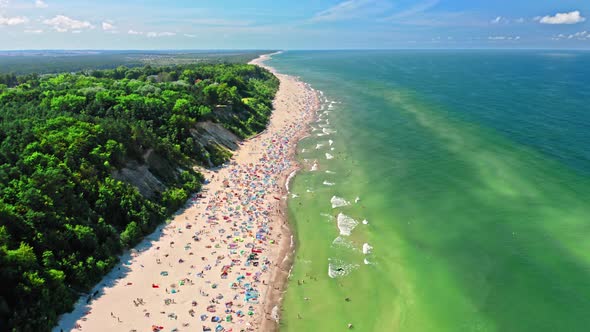Crowded beach by Baltic Sea. Aerial view of tourism, Poland.