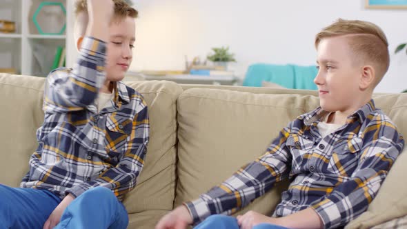 Identical Twin Boys Doing Fist Bumps