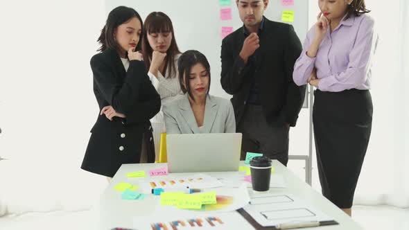 Business People Proficiently Discuss Work Project on Computer