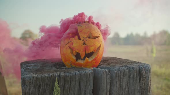 Spooky Carved Halloween Pumpkin with Red Smoke