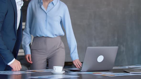 Two colleagues with a laptop at a meeting