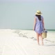 Young Woman Walks Barefoot On Beach Along Ocean - VideoHive Item for Sale
