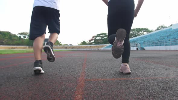 Legs Boy And Girl Running At Stadium