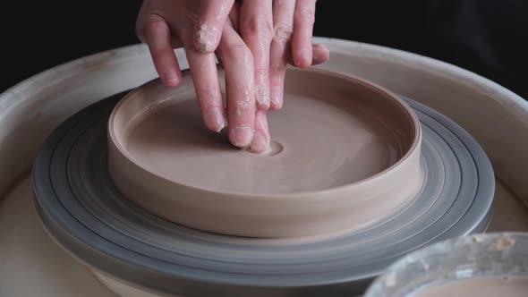 A Woman Works on a Potter's Wheel