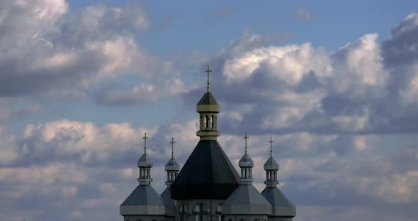 Time Lapse of Ancient Church Bell Tower Silhouette Against Spindrift Clouds in Sunset Over Old Town