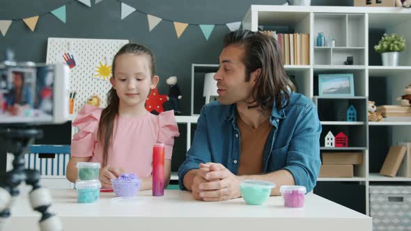 Kid and Father Mixed Race Family Recording Content for Internet Vlog Talking About Playdough Using