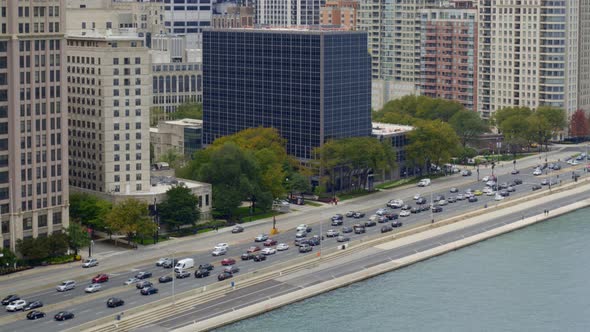 Aerial of a busy street and skyscrapers along coast of Lake Michigan