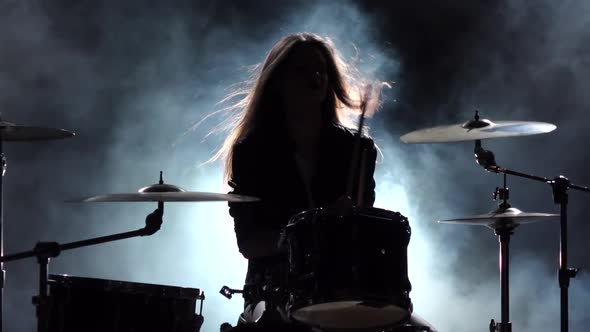 Girl Plays the Drum She Likes To Pound on Pancakes, Black Smoke Background, Slow Motion, Silhouette