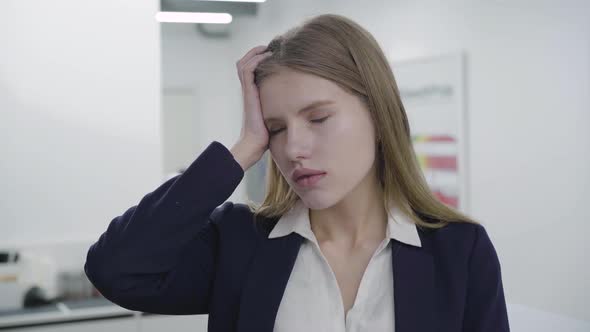 Portrait of Sad Tired Young Lady in Formal Clothes Looking in Camera. Woman with Long Hair Had