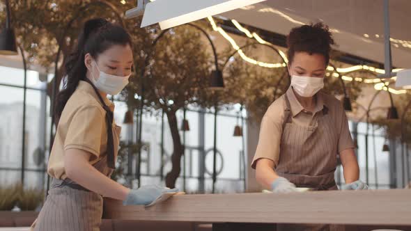 Diverse Women Wiping Cafe Table