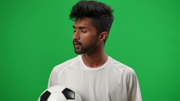 Young Perspiring Middle Eastern Footballer Wiping Sweat Off Forehead Sighing Looking at Camera