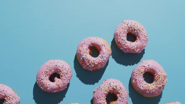 Video of donuts with icing on blue background