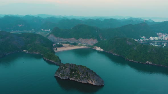 Aerial: flying over Cat Ba island at dusk, Ha Long Bay famous tourism destination in Vietnam