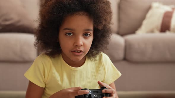 Portrait Little African American Girl Playing Video Game Using Wireless Controller