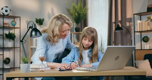 Mother which Rejoycing from Correct Doing Homework by Her Smart Able Daughter