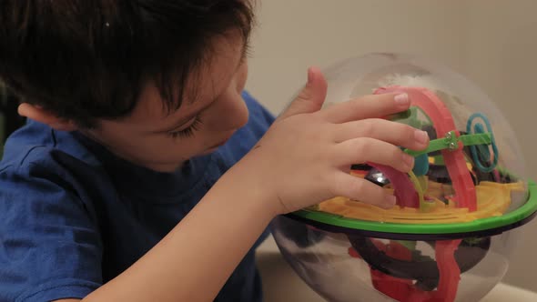 Preschooler Boy Plays with Puzzle Game