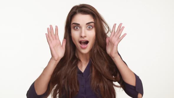 Beautiful Caucasian Female in Dark Blue Shirt and with Long Brown Hair Standing on White Background