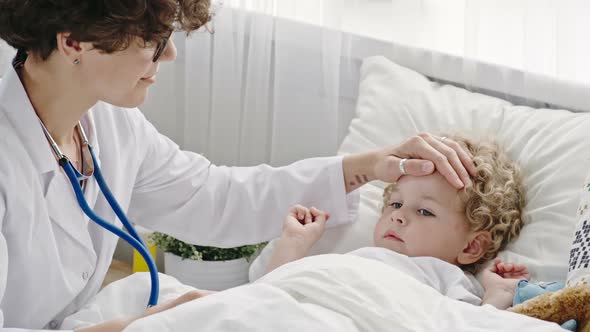 Caring Mother Playing Doctor with Toddler Boy