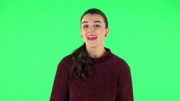 Lovely Girl Smiles Broadly and Winks. Green Screen